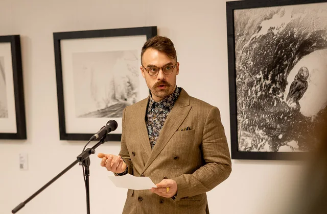 Matej Tomažin speaking at an exhibition.